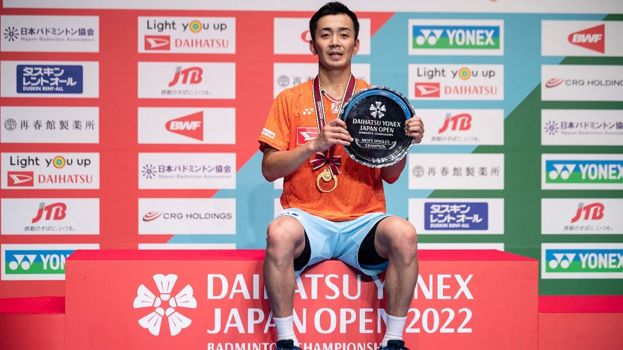 Gold medallist Kenta Nishimoto of Japan poses on the podium after his victory against Chou Tien-chen of Taiwan during the men's singles final on day six of the Japan Open badminton. Credit: AFP Photo