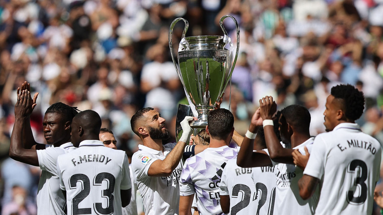 Real Madrid's French forward Karim Benzema (C) and teammates hold the UEFA Champions League trophy. Credit: AFP Photo