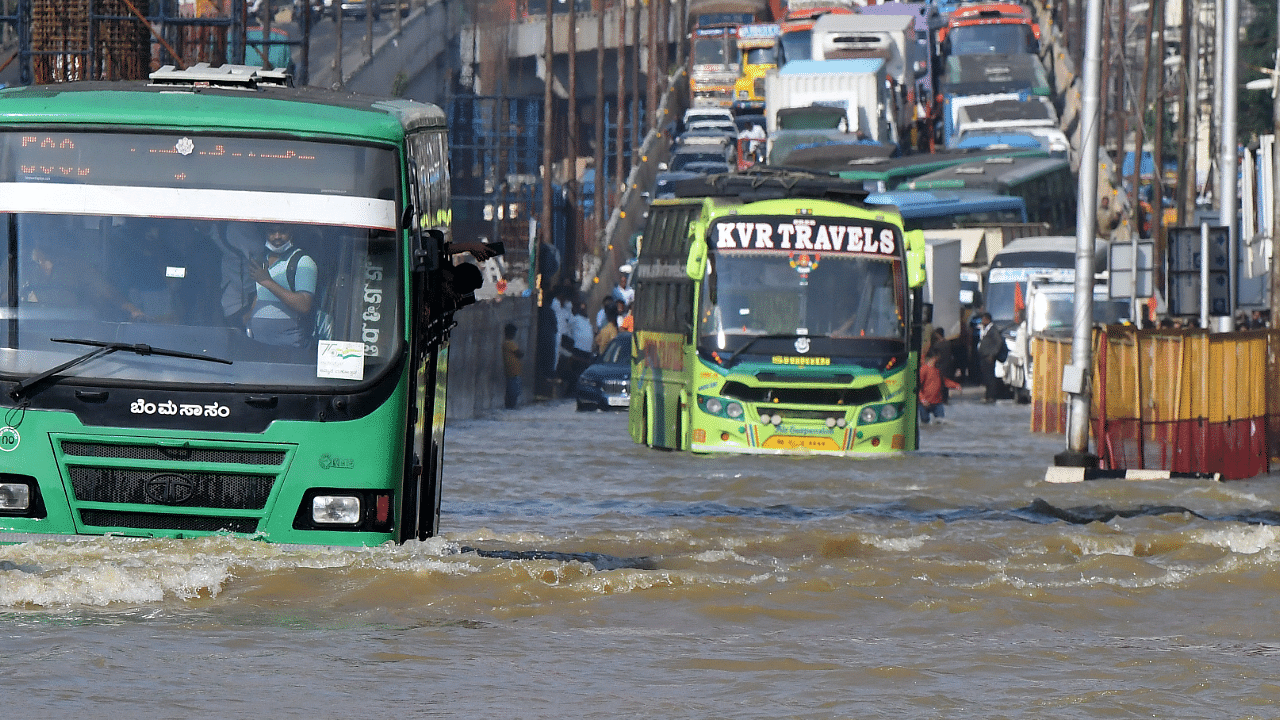 Traffic moves through a water-logged road following torrential rains in Bengaluru. Credit: Reuters Photo