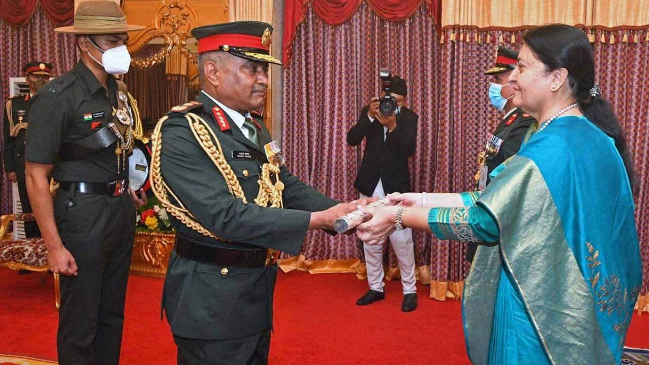Nepal's President Bidya Devi Bhandari (R) confers India's Chief of Army Staff General Manoj Pande with the honorary rank of General of Nepal's Army. Credit: AFP Photo