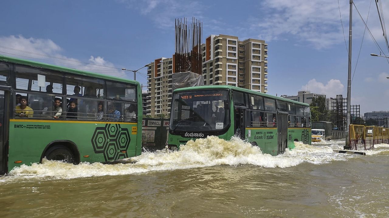 Vehicles move through the waterlogged Outer Ring Road after heavy monsoon rains, in Bellandur, Bengaluru. Credit: PTI Photo