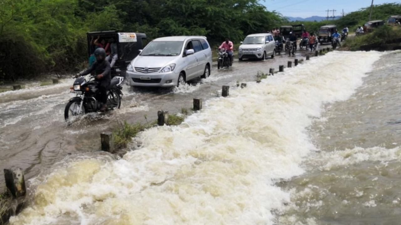 Crops on vast tracts of farmland were damaged due to swollen Suvarnavathi river and Chikka Tore in Chamarajanagar taluk. Credit: DH Photo