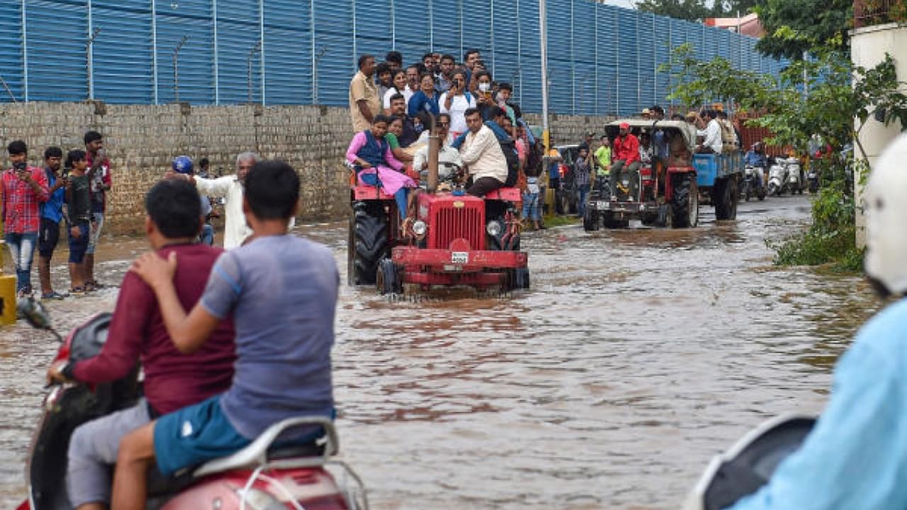 Tractors being used to evacuate people stranded at the waterlogged Yemalur area after heavy monsoon rains, in Bengaluru, Tuesday, Sept. 6, 2022. Credit: PTI Photo