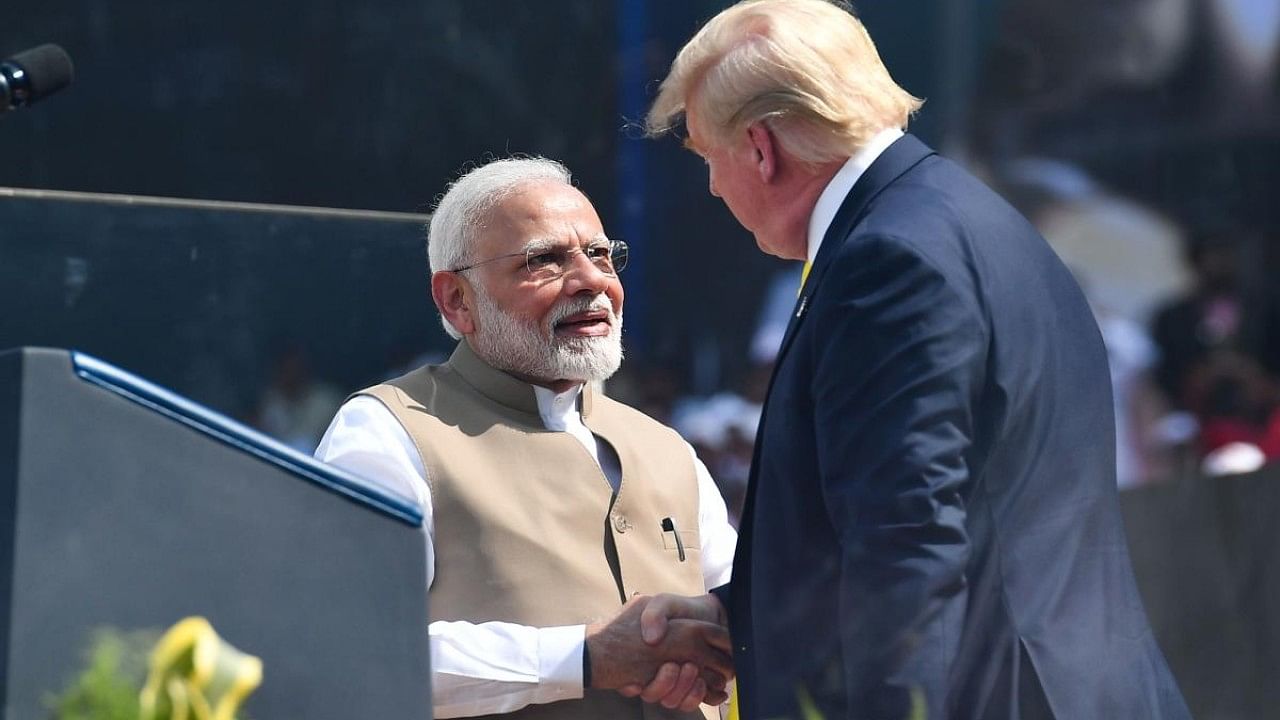 Former US president Donald Trump (R) shakes hands with India's Prime Minister Narendra Modi. Credit: AFP Photo
