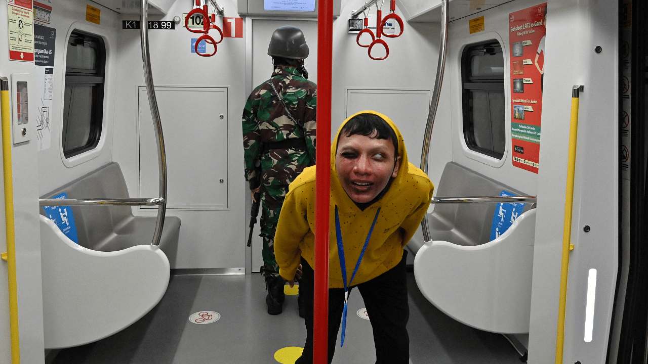 A performer acting as a zombie on board an LRT coach as part of the "Train to Apocalypse" event. Credit: AFP Photo