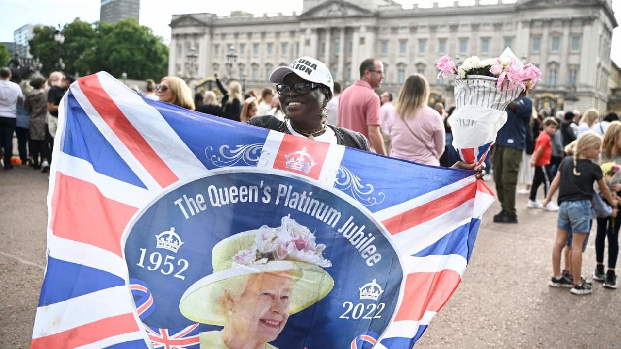 A flag with the portrait of Britain's Queen Elizabeth II. Credit: AFP Photo