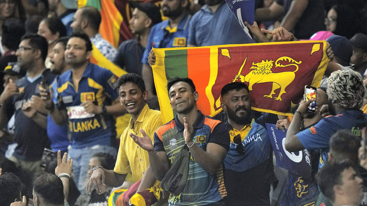 Sri Lankan supporters cheer for their team. Credit: AP Photo