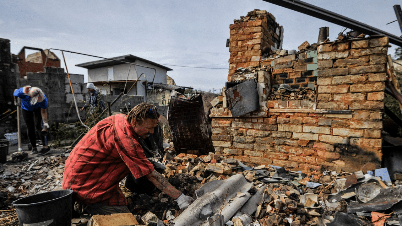 Volunteers clear the rubble of a destroyed house as a result of shelling in village of Moshchun, Kyiv region, on September 9, 2022, amid the Russian military invasion of Ukraine. Credit: AFP Photo