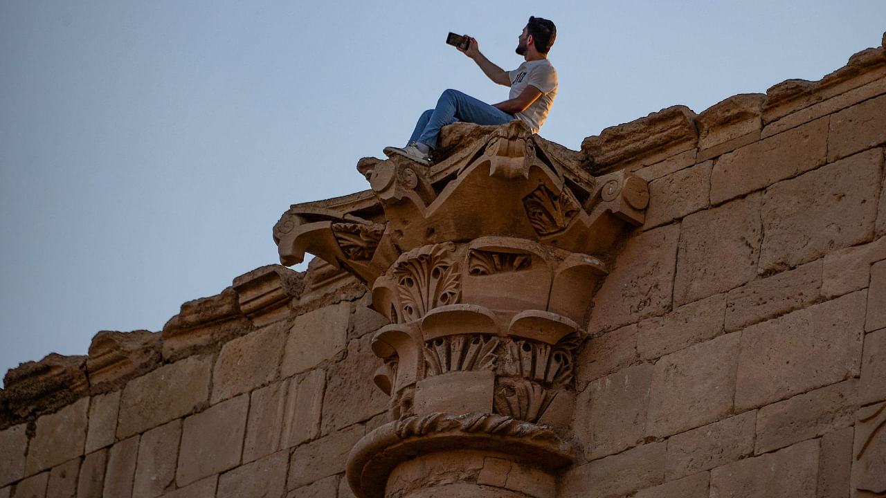 A tourist visits the ancient city of Hatra in northern Iraq on September 10, 2022, as local authority initiatives seek to encourage tourism and turn the page on the years of violence by the Islamic State IS group. Credit: AFP Photo