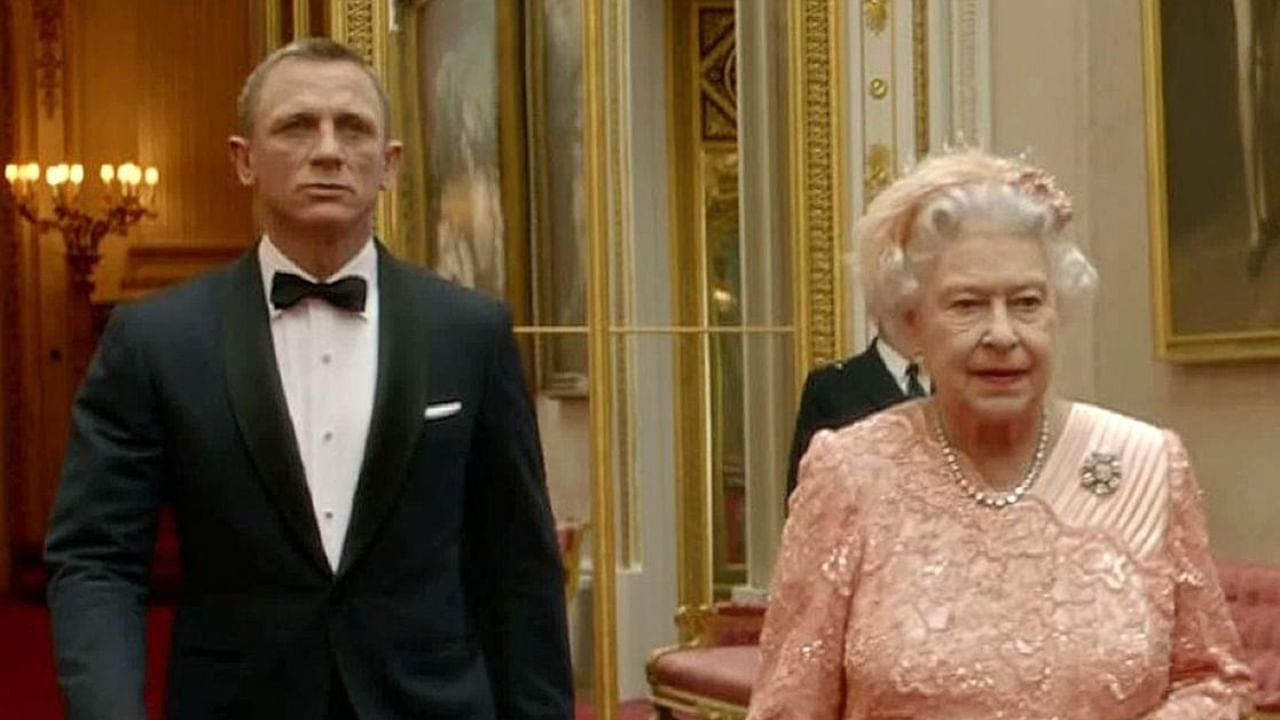 In this file television screen grab image taken on July 29, 2012, shows footage featured during the Opening Ceremony of the London 2012 Olympic Games starring British actor Daniel Craig (L) playing James Bond escorting Britain's Queen Elizabeth II through the corridors of Buckingham Palace. Credit: AFP Photo