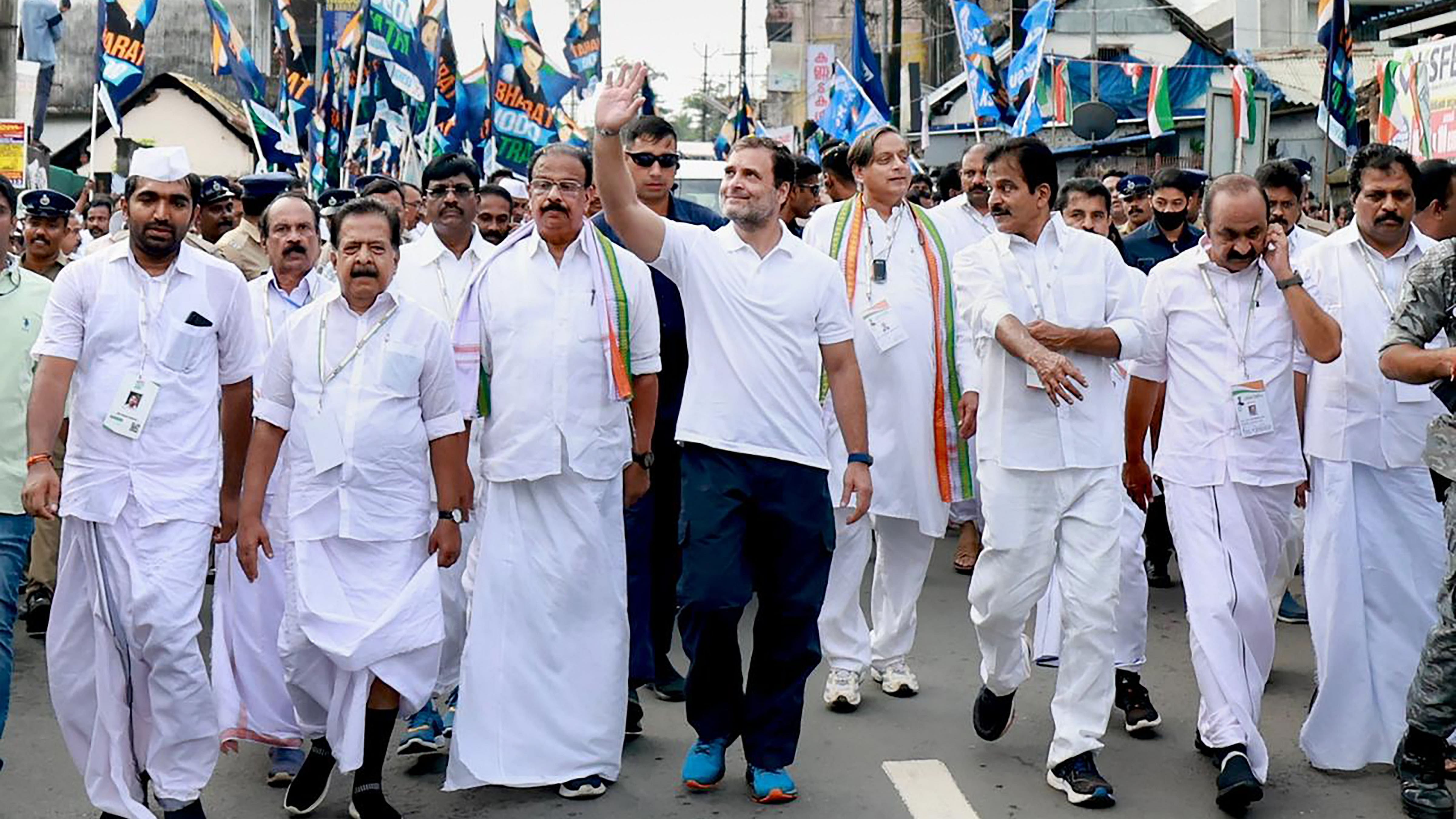 Congress leader Rahul Gandhi with party leaders waves at supporters during the 'Bharat Jodo Yatra' at Parassala, Thiruvananthapuram. Credit: PTI Photo