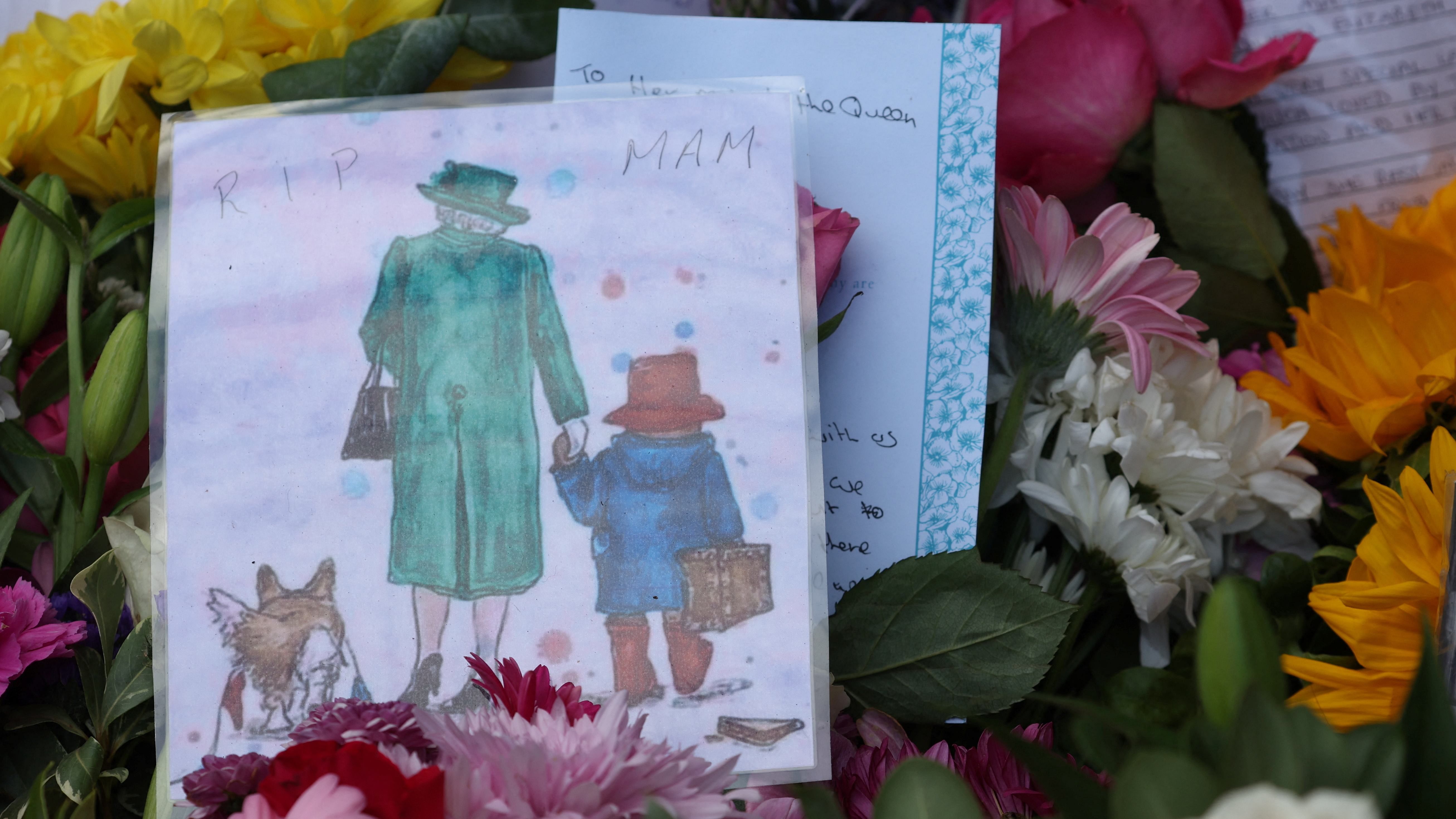 The queen's body currently rests in an oak coffin covered with the royal standard of Scotland and with a wreath of flowers laid on top in the ballroom of Balmoral Castle. Credit: Reuters Photo 