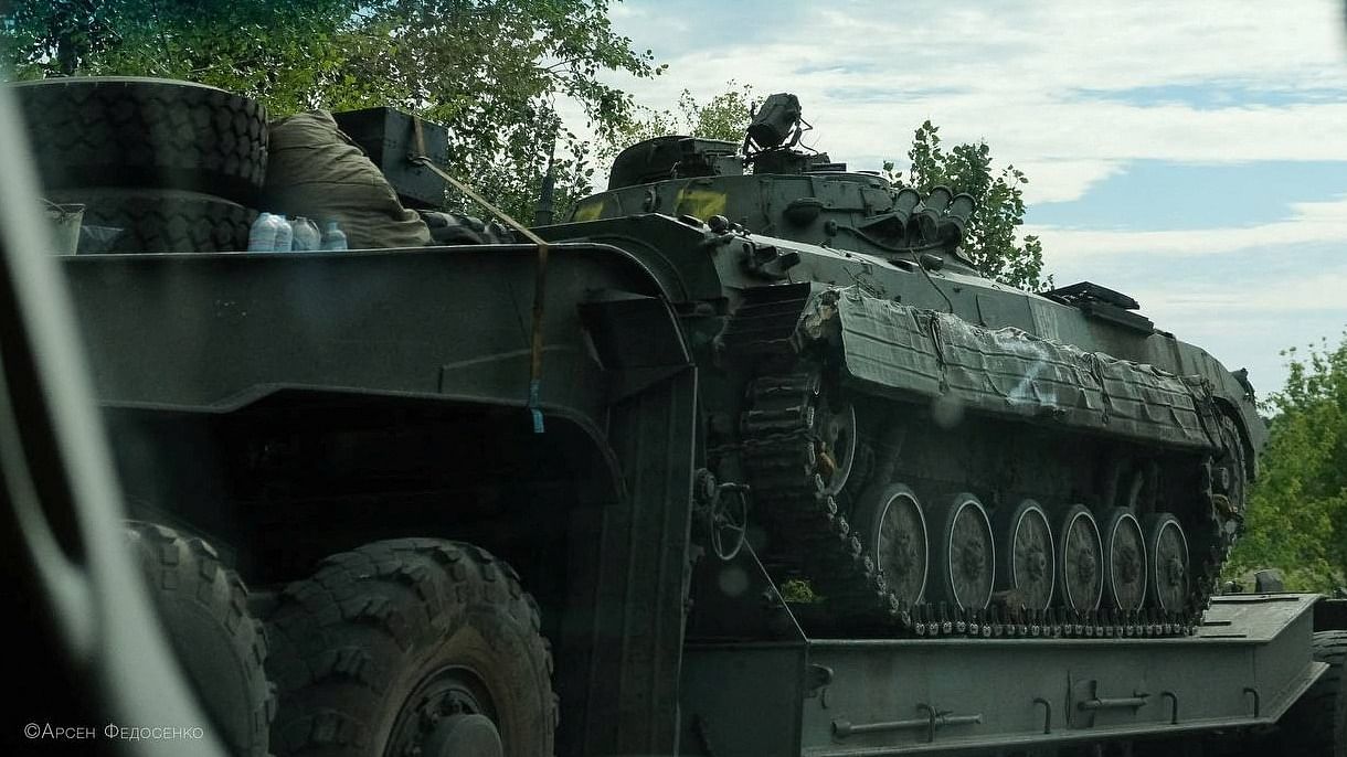 Ukrainian service members transport a Russian armoured fighting vehicle captured during a counteroffensive operation, amid Russia's attack on Ukraine, in Kharkiv region. Credit: Reuters Photo