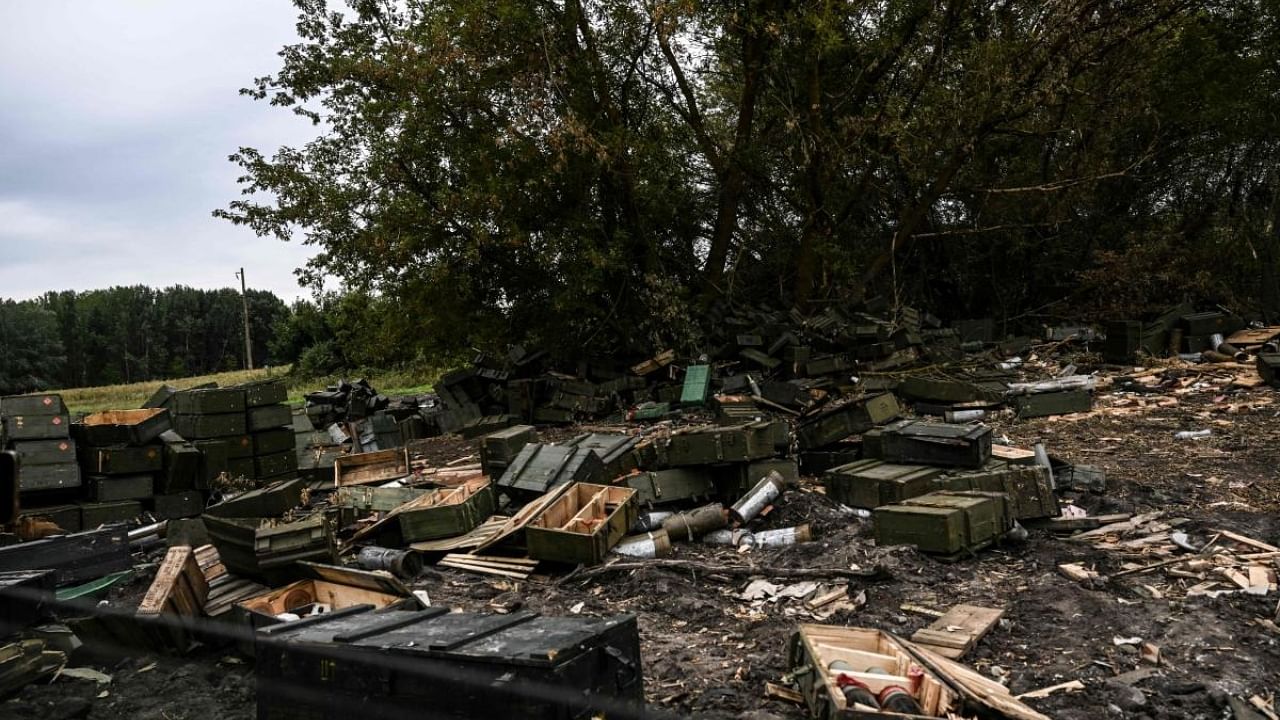 This photograph taken on September 10, 2022, shows abandoned weapons crates in Balakliya, Kharkiv region, amid the Russian invasion of Ukraine. Credit: AFP Photo