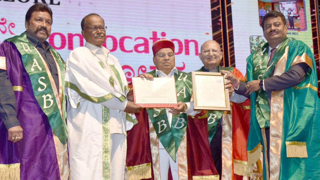 Farmer N C Patel (second from left) receives the honorary doctorate degree from Governor-Chancellor Thaawar Chand Gehlot at the 56th convocation of the University of Agricultural Sciences in Bengaluru on Friday. Credit: DH photo/B K Janardhan