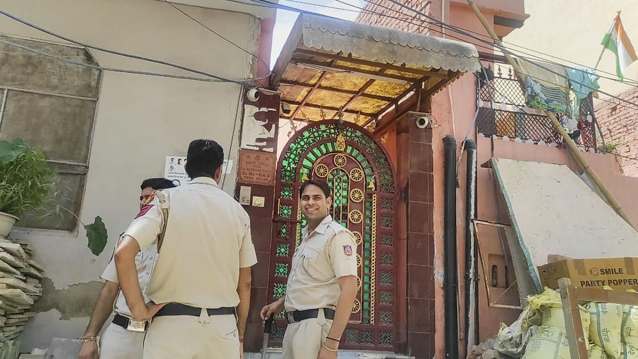 Police personnel deployed during a raid by National Investigation Agency (NIA) officials in connection with a case related to narco-terrorism by alleged gangsters, at Bawana village in Outer Delhi. Credit: PTI Photo