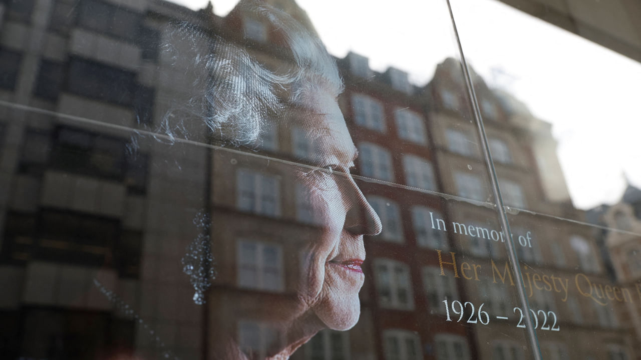 A sign with a picture of the queen is displayed in an office window, in London, Britain, September 12, 2022. Credit: Reuters Photo