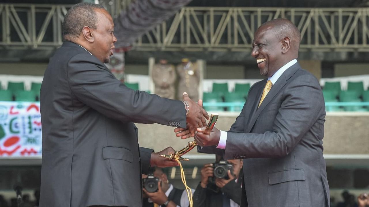 Former Kenyan president Uhuru Kenyatta shakes hands with incoming President William Ruto at the Moi International Sports Center Kasarani in Nairobi. Credit: AFP Photo