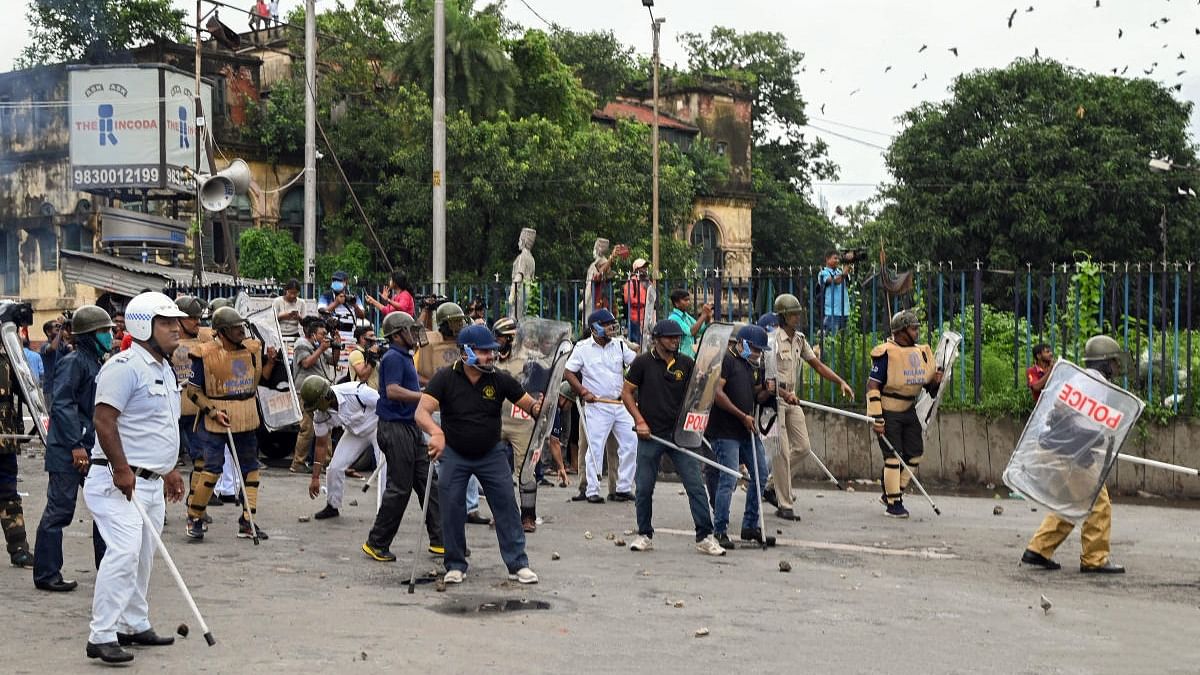 Security personnel attempt to disperse BJP supporters from the Howrah Bridge during their 'Nabanna Abhijan' (March to Secretariat) to protest against alleged corrupt practices of TMC government, in Kolkata. Credit: PTI Photo