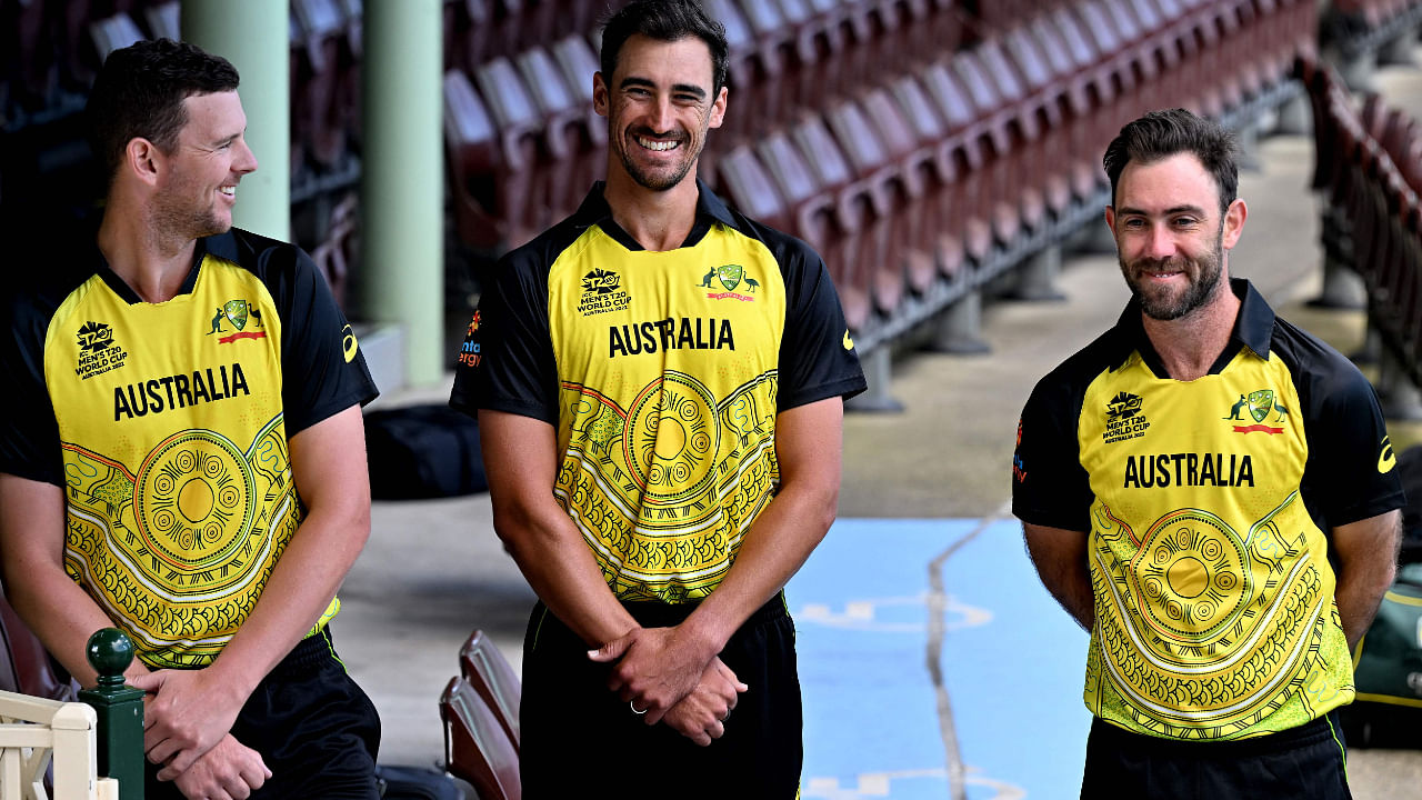 Australia's cricket players Mitchell Starc (C), Josh Hazlewood (L) and Glenn Maxwell pose for pictures with new First Nations kit design for the upcoming ICC Men's T20 World Cup. Credit: AFP Photo