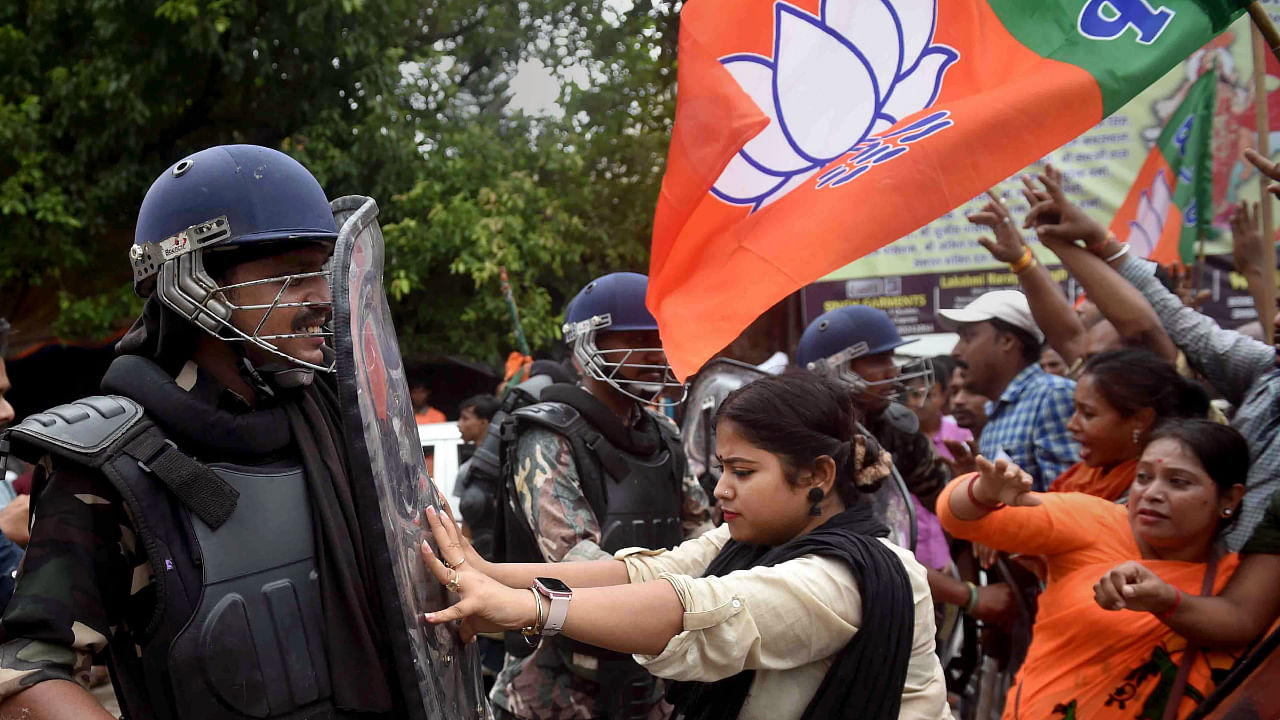 A BJP supporter pushes a security personnel during BJP's 'Nabanna Abhijan', September 13, 2022. Credit: PTI Photo