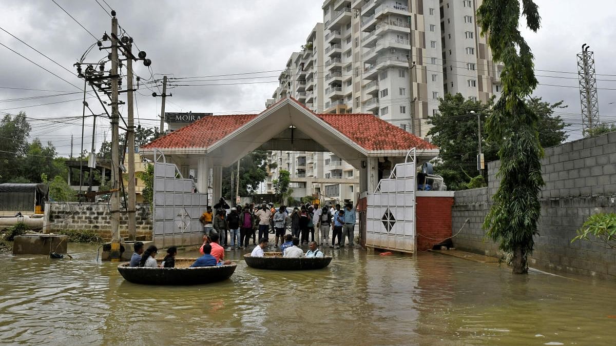 People use Coracle boats to move through a water-logged neighbourhood following torrential rains in Bengaluru. Credit: Reuters file photo