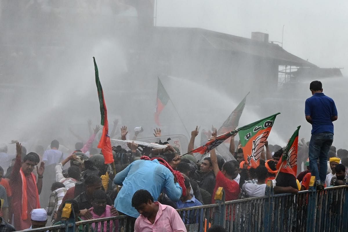 Police use a water cannon to disperse Bharatiya Janata Party (BJP) activists marching towards the state secretariat during a protest against West Bengal's government in Kolkata on September 13. Credit: AFP Photo