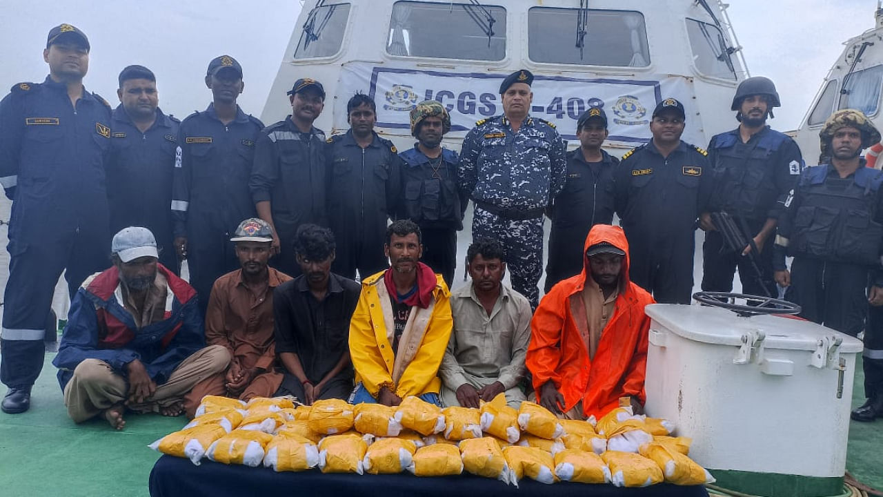 ICG personnel with the seized drugs and Pakistani handlers. Credit: Indian Coast Guard