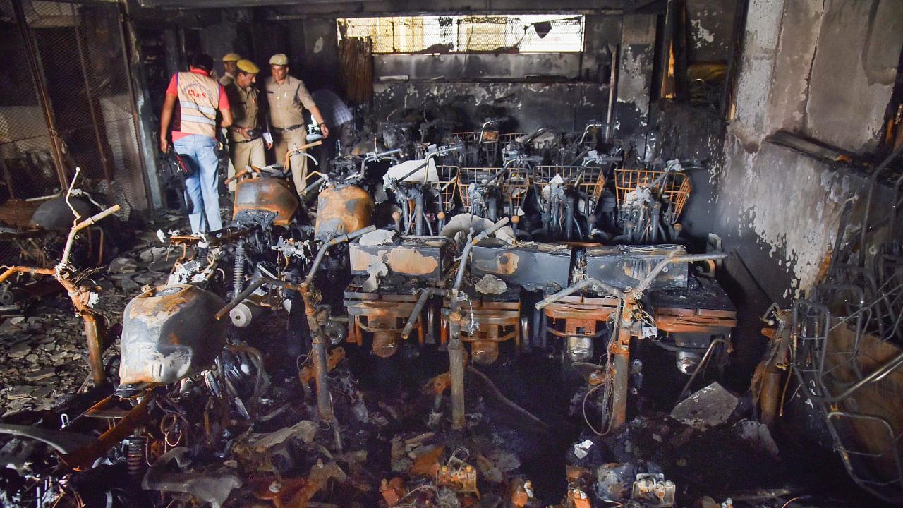 Hyderabad Police and members of their Clues team at the site after a fire broke out in an electric bike showroom on Monday. Credit: PTI Photo