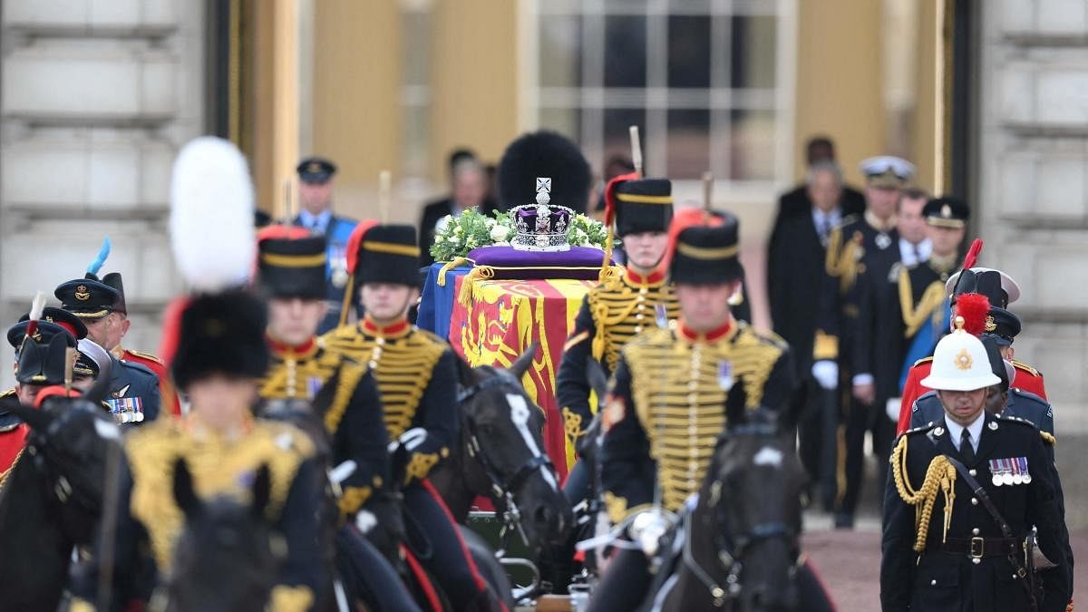 The coffin of Queen Elizabeth II, adorned with a Royal Standard and the Imperial State Crown and pulled by a Gun Carriage of The King's Troop Royal Horse Artillery, is pictured during a procession from Buckingham Palace to the Palace of Westminster. Credit: AFP Photo