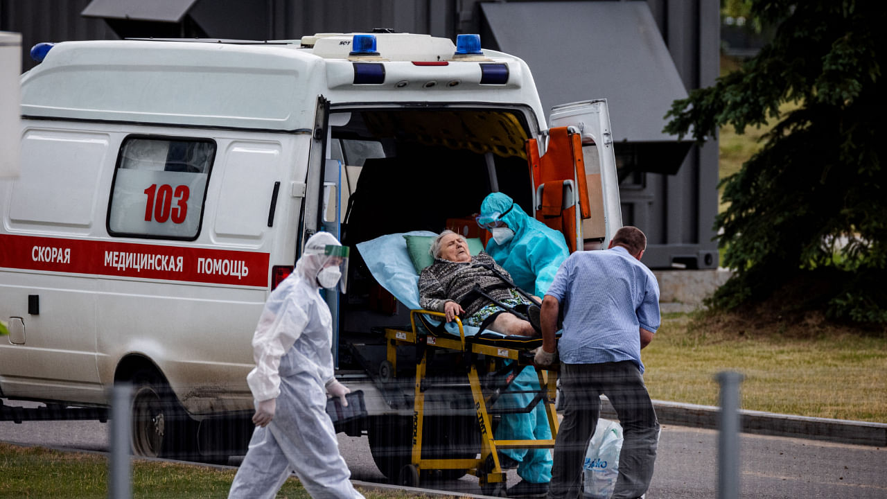 Medics escort a woman into a hospital for Covid-19 patients in Moscow, June 30, 2021. Credit: AFP File Photo