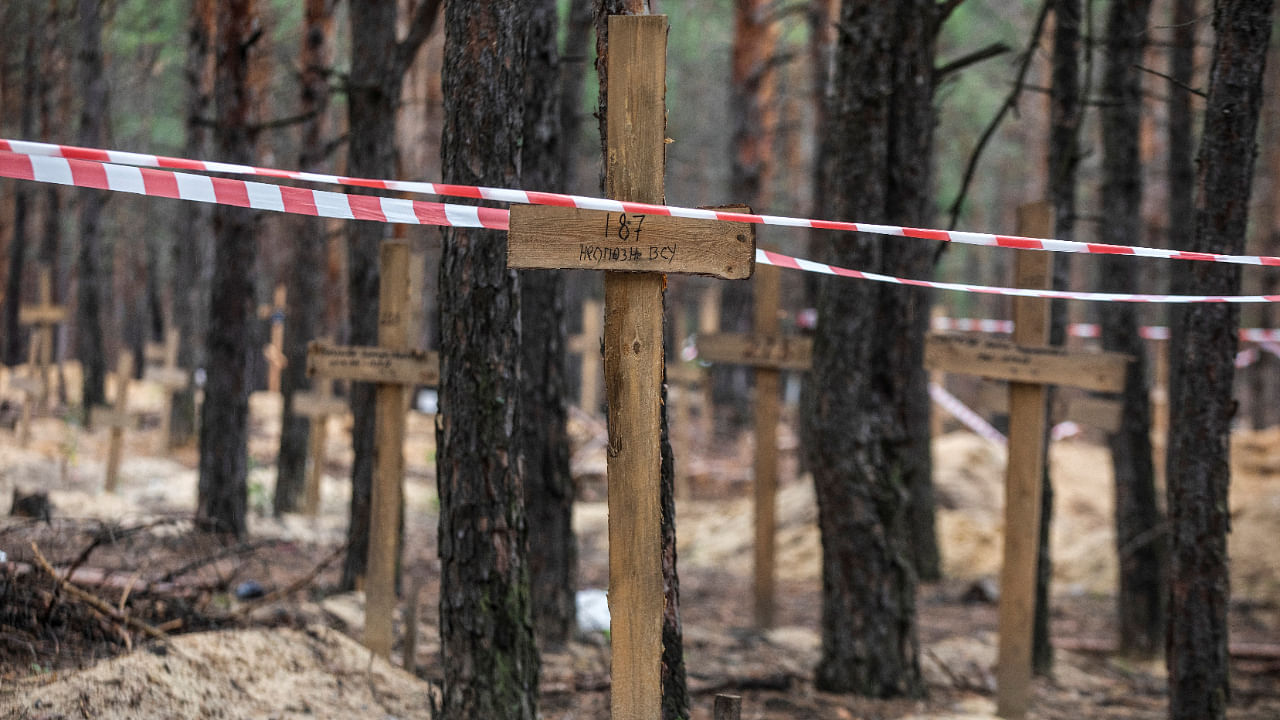 Signal tape is seen over a grave of an unidentified Ukrainian soldier at an improvised cemetery in the town of Izium, recently recently liberated by the Ukrainian Armed Forces during a counteroffensive operation, amid Russia's attack on Ukraine. Credit: Reuters Photo