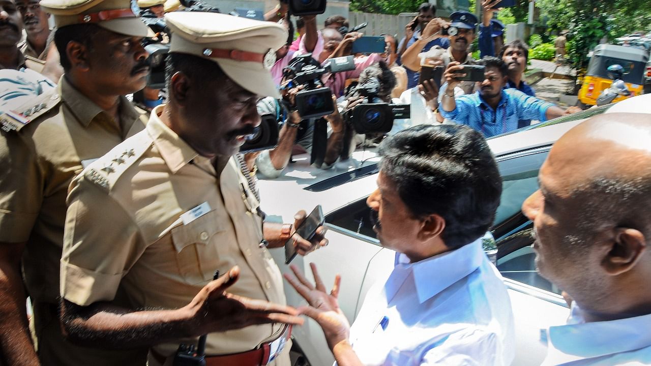 AIADMK leaders speak with police personnel in support of former TN minister and party leader C Vijayabaskar during a search at his premises by Directorate of Vigilance and Anti-Corruption (DVAC), in Chennai. Credit: PTI Photo