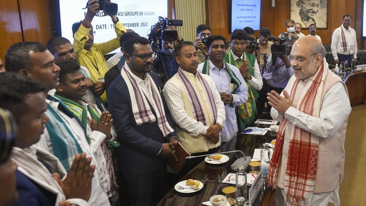 Union Home Minister Amit Shah meets tribal leaders during signing of a peace agreement with eight tribal militant organisations ('Adivasi' groups) of Assam. Credit: PTI Photo