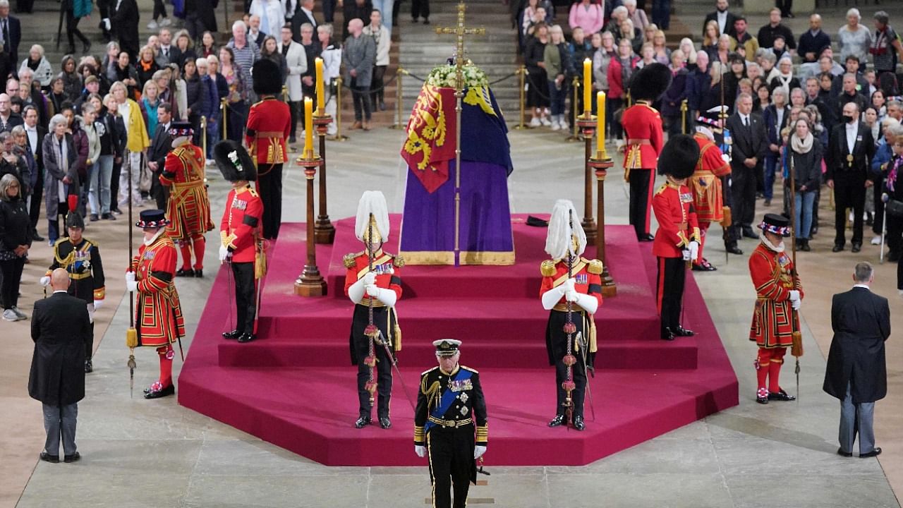 Britain's King Charles III leaves at the end of a vigil around the coffin of Queen Elizabeth II. Credit: AFP Photo