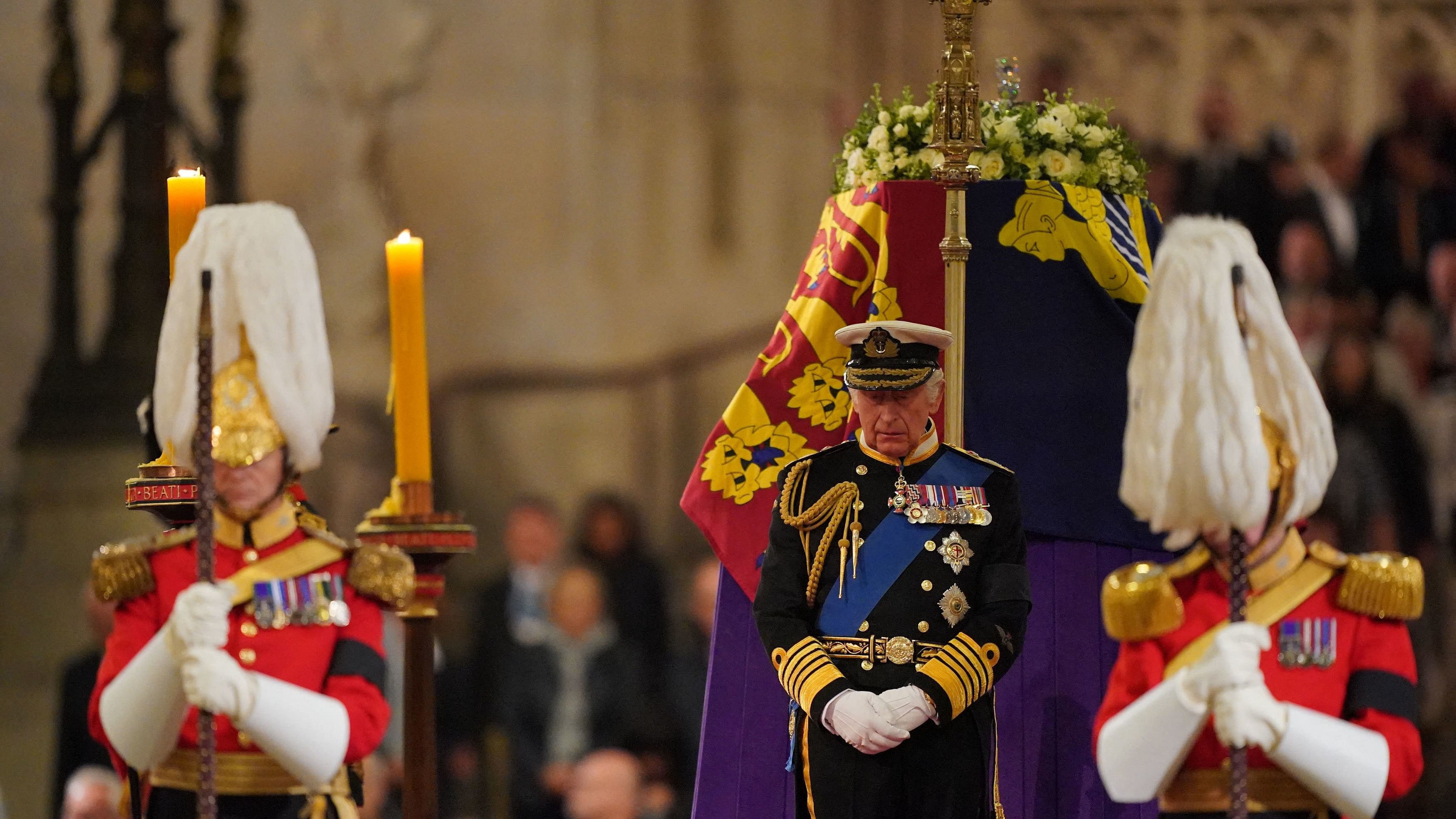 Britain's King Charles III attends a vigil around the coffin of Queen Elizabeth II, draped in the Royal Standard with the Imperial State Crown and the Sovereign's orb and sceptre, lying in state on the catafalque in Westminster Hall, at the Palace of Westminster in London. Credit: AFP Photo