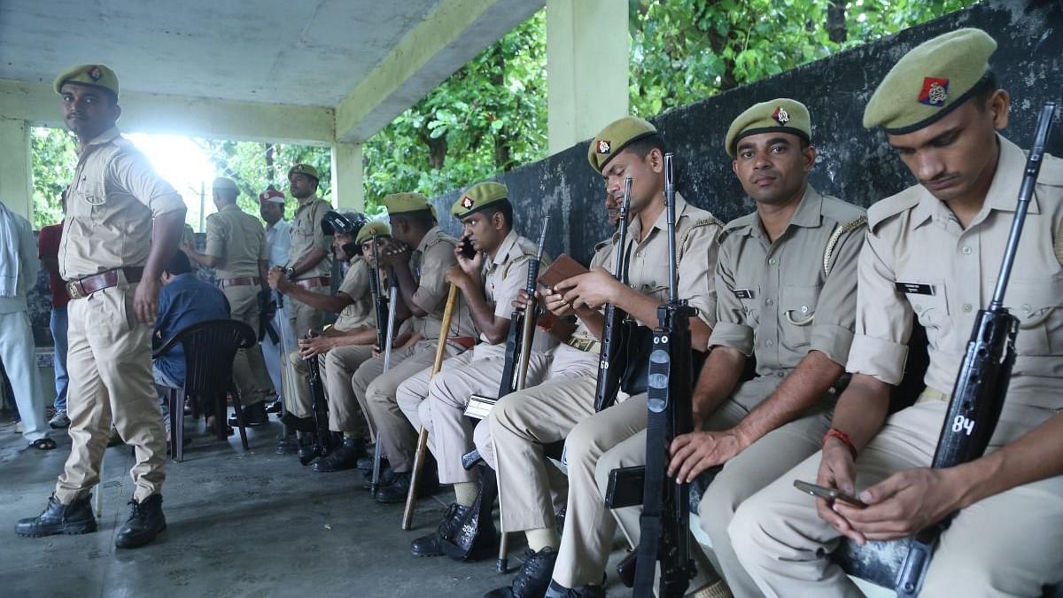 Security personnel outside a mortuary during post-mortem of one of two minor Dalit sisters allegedly raped and murdered in Lakhimpur Kheri. Credit: PTI Photo