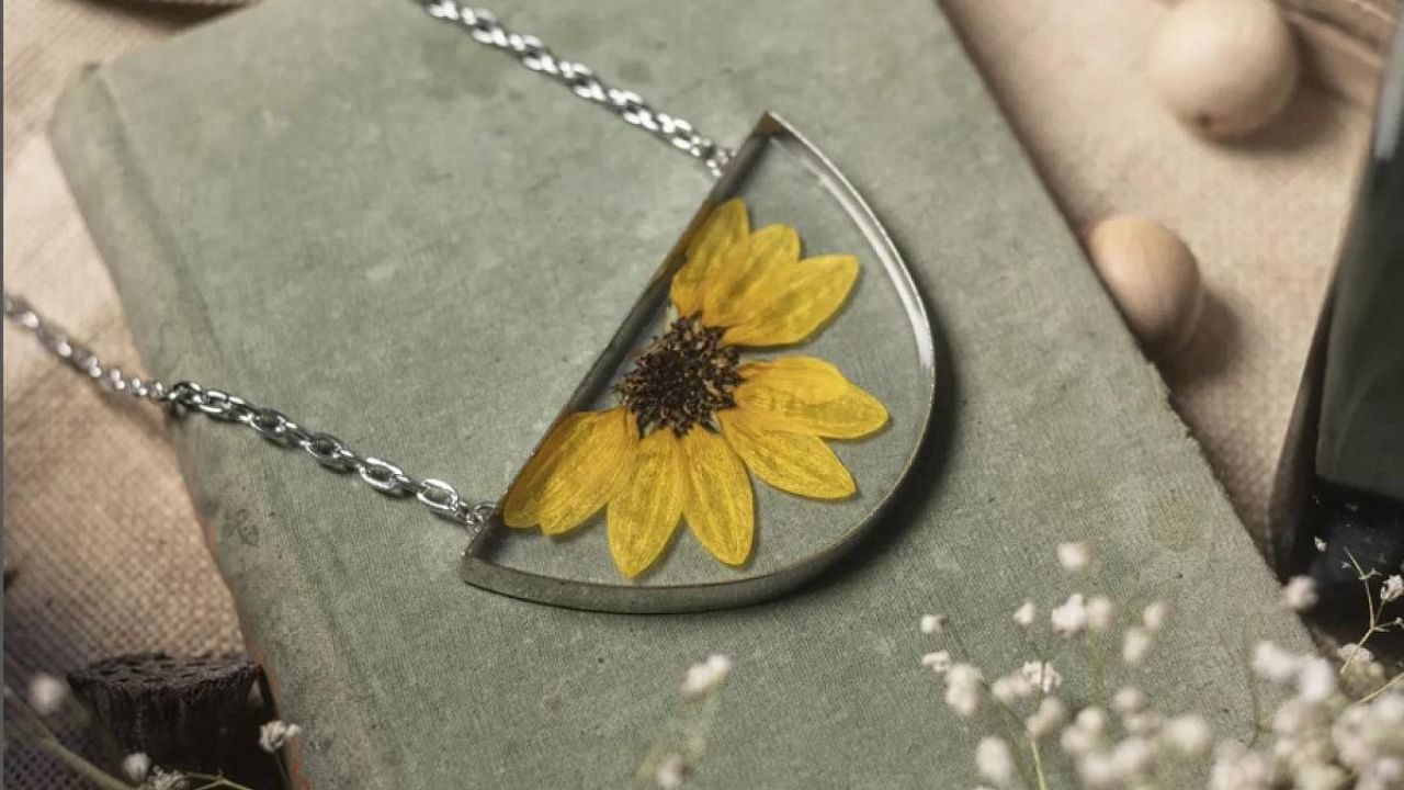 A pendant from Leafy Affair with a pressed sunflower inside. Credit: Special arrangement
