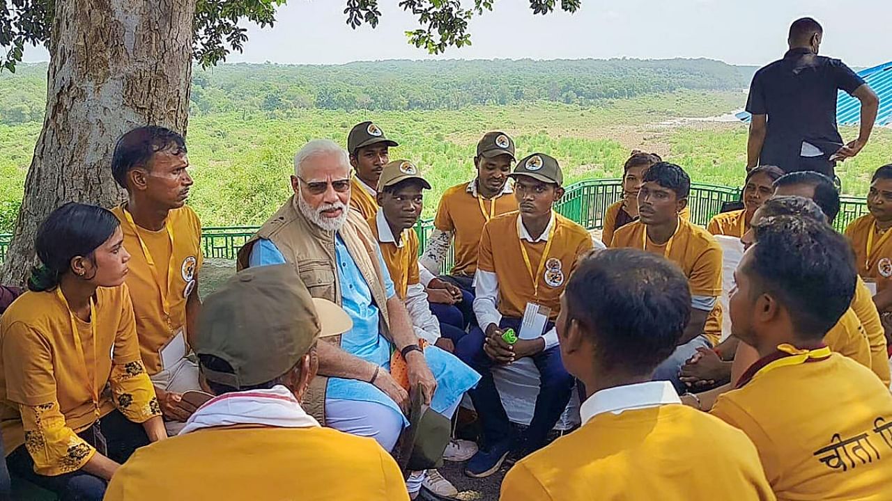 Prime Minister Narendra Modi speaks with wildlife caretakers after releasing cheetahs inside a special enclosure of the Kuno National Park in Madhya Pradesh, Saturday, September 17, 2022. Credit: PTI Photo