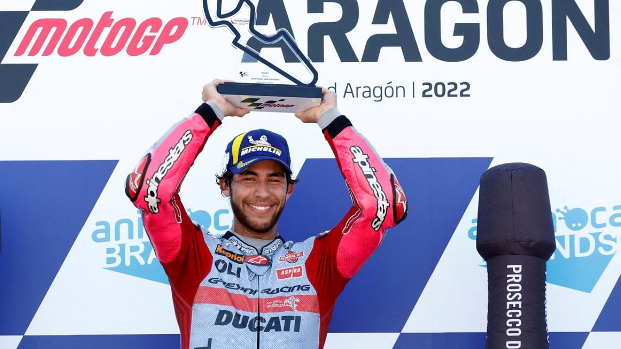 Gresini Racing MotoGP's Enea Bastianini celebrates with the trophy on the podium after winning the MotoGP race. Credit: AFP Photo