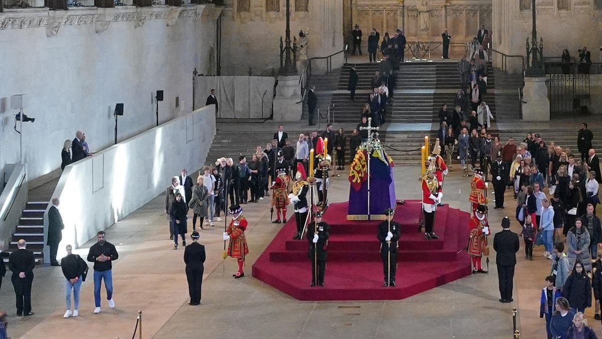US President Joe Biden and First Lady Jill Biden (on raised platform left of coffin) view the coffin of Queen Elizabeth II, lying in state on the catafalque in Westminster Hall, at the Palace of Westminster, London. Credit: Reuters photo