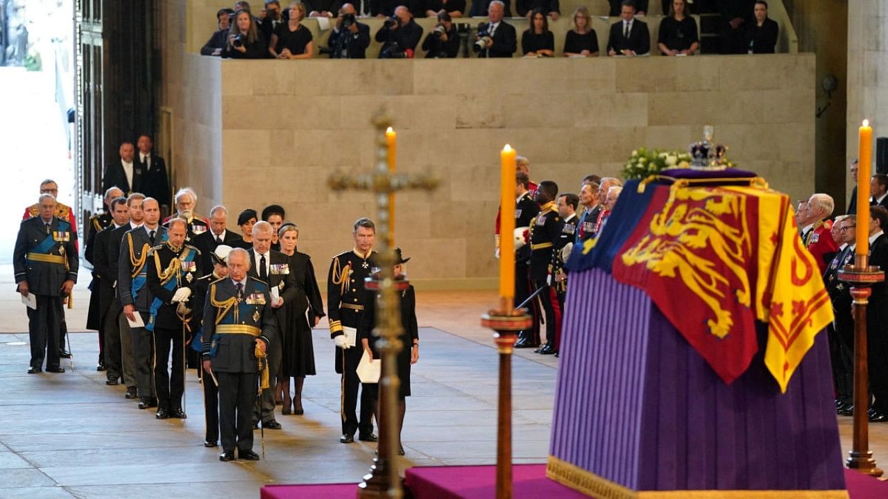 Members of the royal family including King Charles III, the Princess Royal, the Earl of Wessex, the Prince of Wales and Duke of Sussex stand behind the coffin of Queen Elizabeth II as it lies on the catafalque in Westminster Hall, London, where it will lie in state ahead of her funeral on Monday. Credit: Reuters Photo