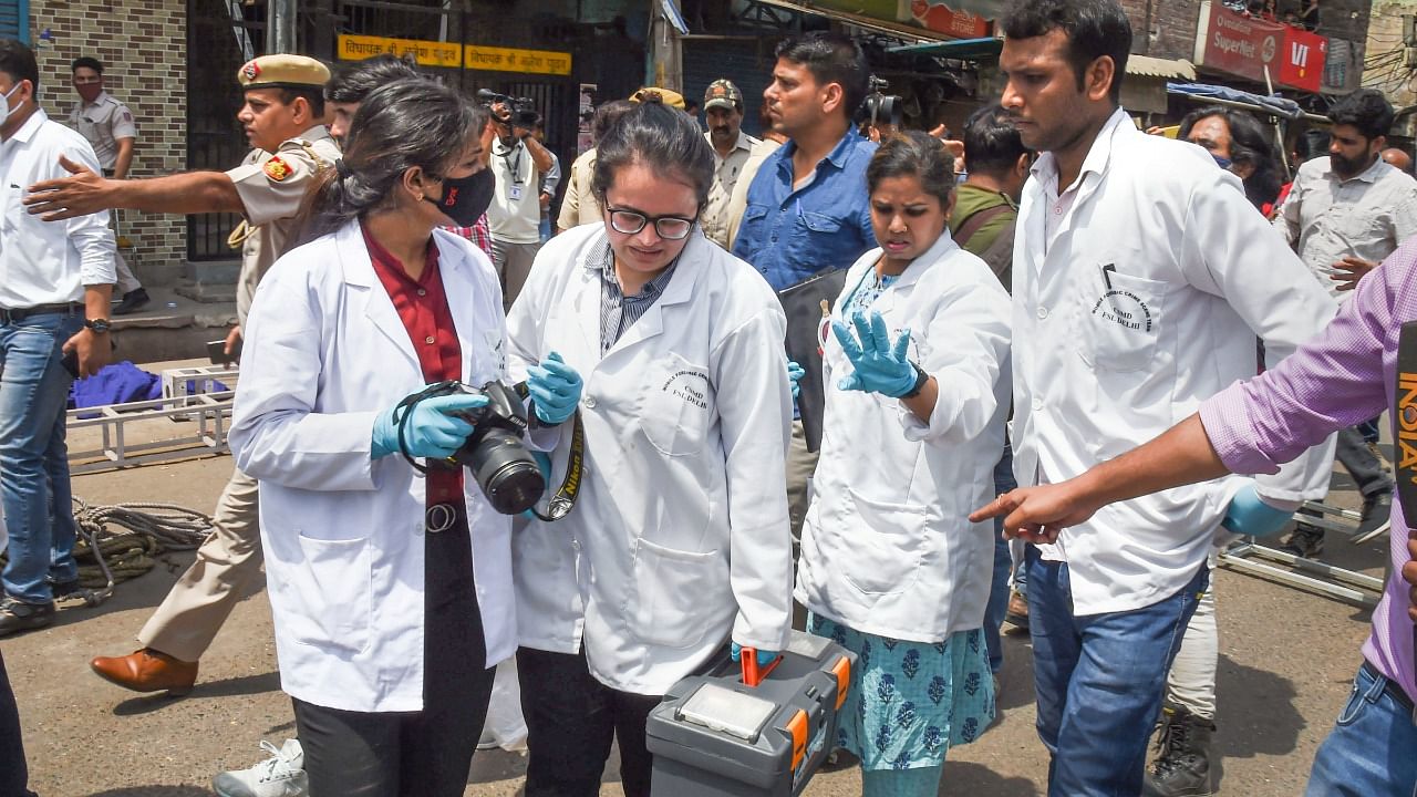 Forensic team leave after collecting evidence, after clashes broke out between two communities during a Hanuman Jayanti procession on Saturday, at Jahangirpuri. Credit: PTI Photo