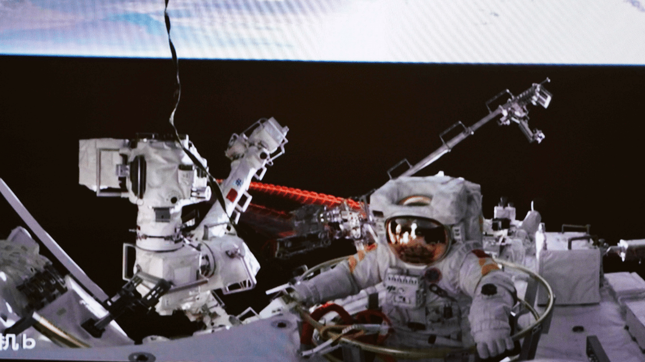 In this photo released by China's Xinhua News Agency, a screen at the Beijing Aerospace Control Center in Beijing shows Chinese astronaut Cai Xuzhe exiting the station lab module Wentian to conduct extravehicular activities, also known as a spacewalk. Credit: AP Photo