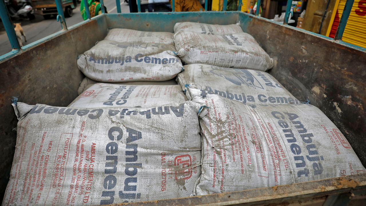 <div class="paragraphs"><p>A view shows Ambuja Cement bags, to be carried to a construction site, in a load carrier in Ahmedabad, July 29, 2022. </p></div>