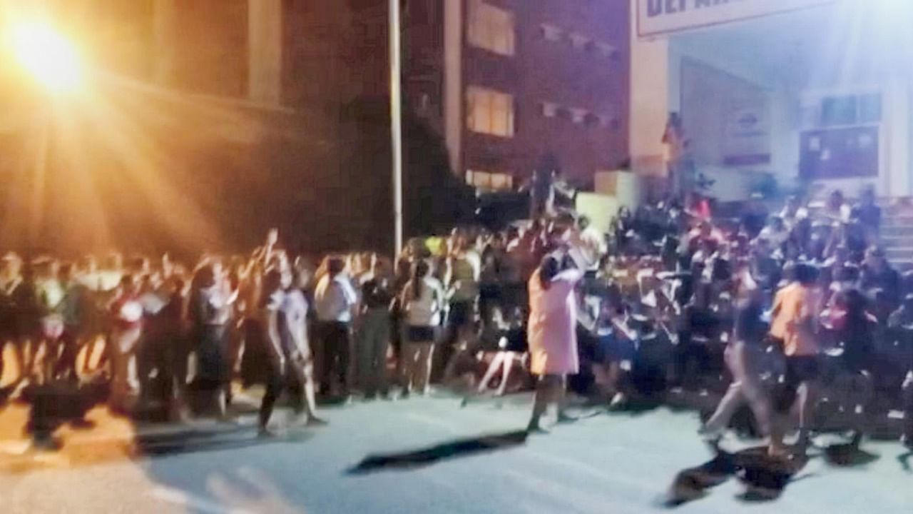 Students of the Chandigarh University protest on the campus after private videos of several women students were posted on social media, in Mohali, Saturday night, Sept. 17, 2022. A woman student who was allegedly involved in sharing the videos online has been apprehended. Credit: PTI Photo