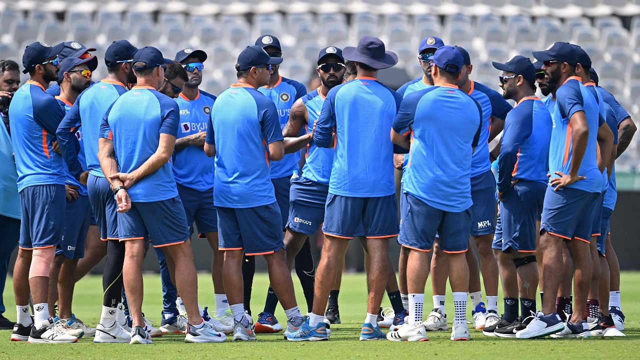 India's players listen to their team coach Rahul Dravid (center L) during a practice session in Mohali on September 18, 2022. Credit: AFP Photo