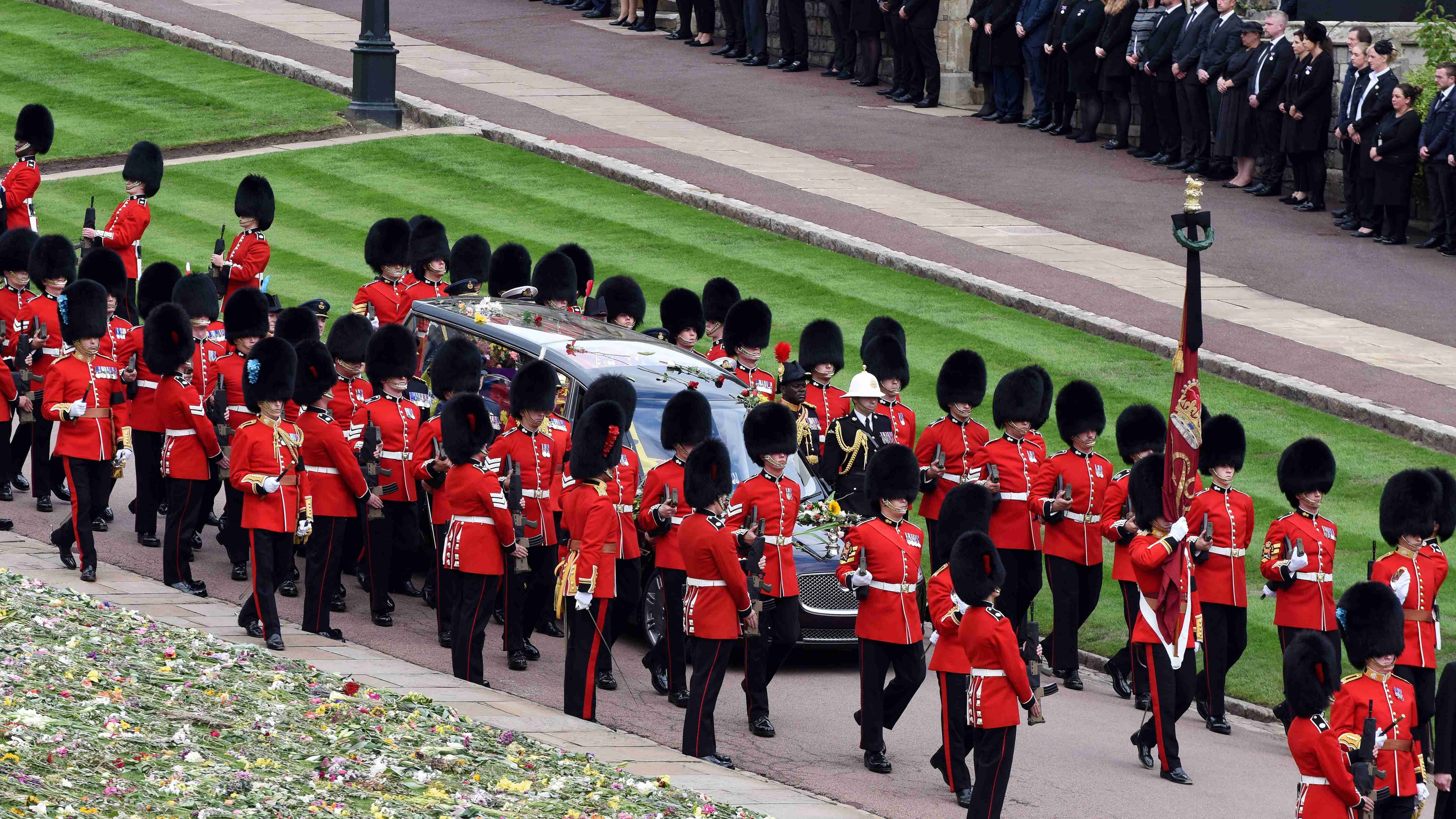 As the coffin was lowered, a lone piper played a haunting lament. Credit: Reuters Photo