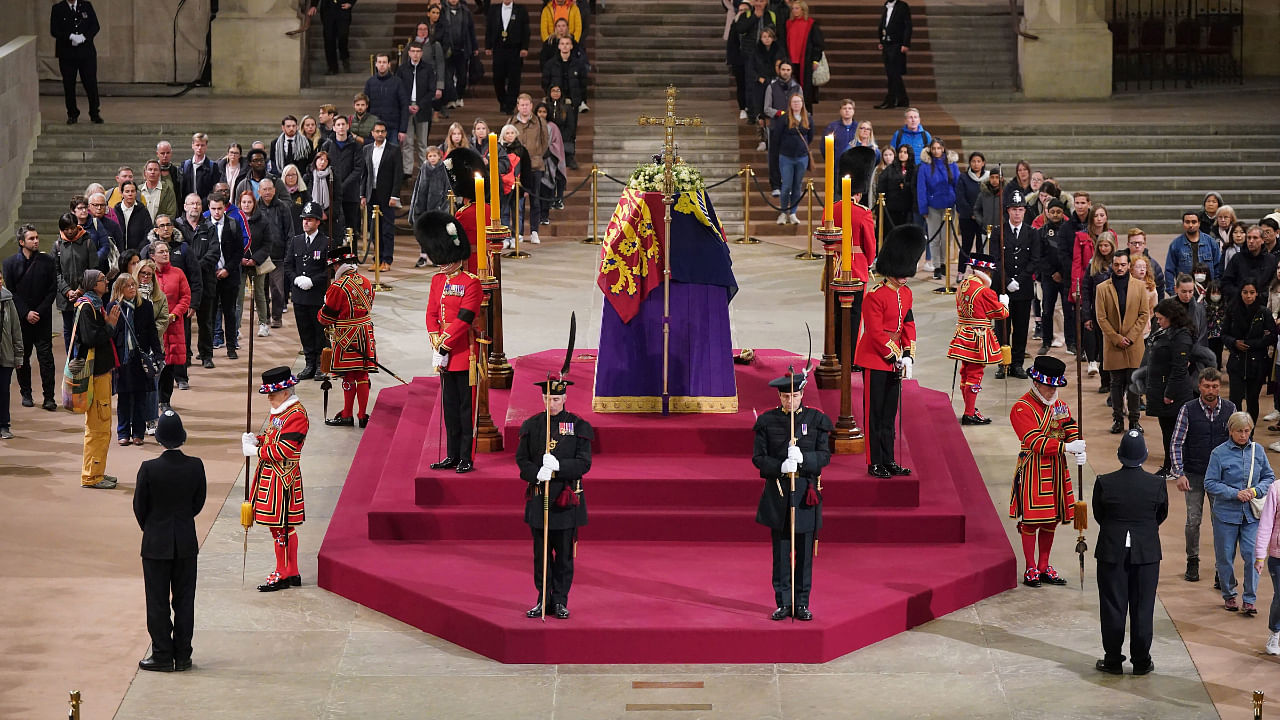 The final members of the public pay their respects at the coffin of Queen Elizabeth II in Westminster Hall at the Palace of Westminster in London early Monday, Sept. 19, 2022. Credit: AP/PTI Photo