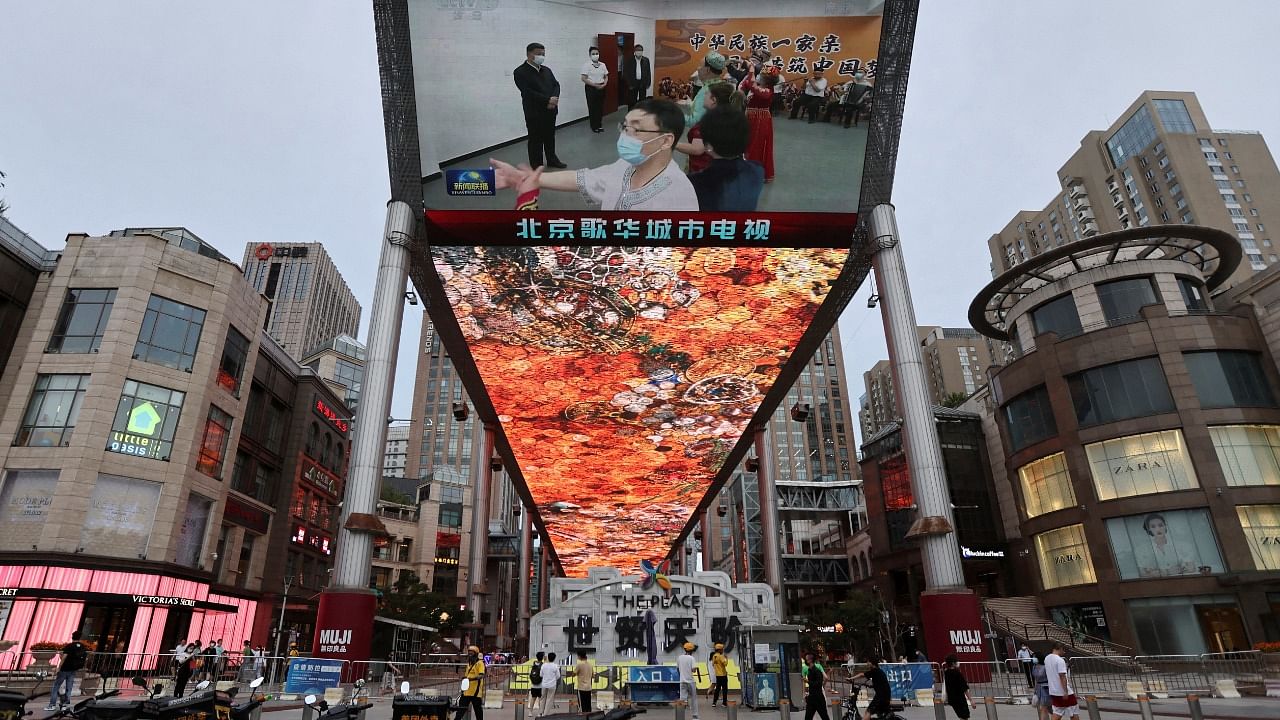 Screen shows news footage of Chinese President Xi Jinping visiting Xinjiang Uyghur Autonomous Region. Credit: Reuters Photo